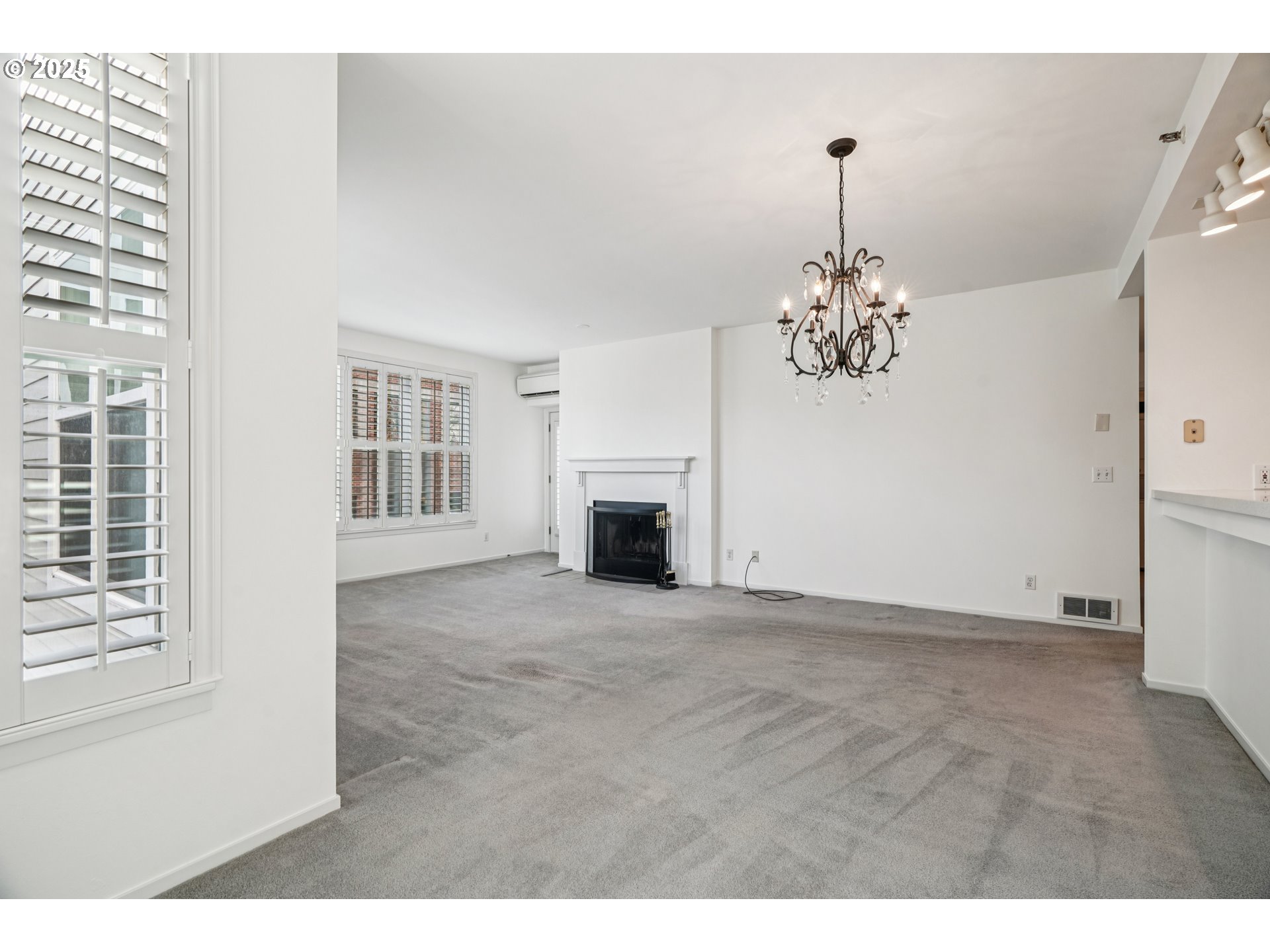 1616 South Harbor Way, Unit 402 Portland, OR 97201 - Photo 5 of 34 a view of a livingroom with a fireplace a chandelier and windows