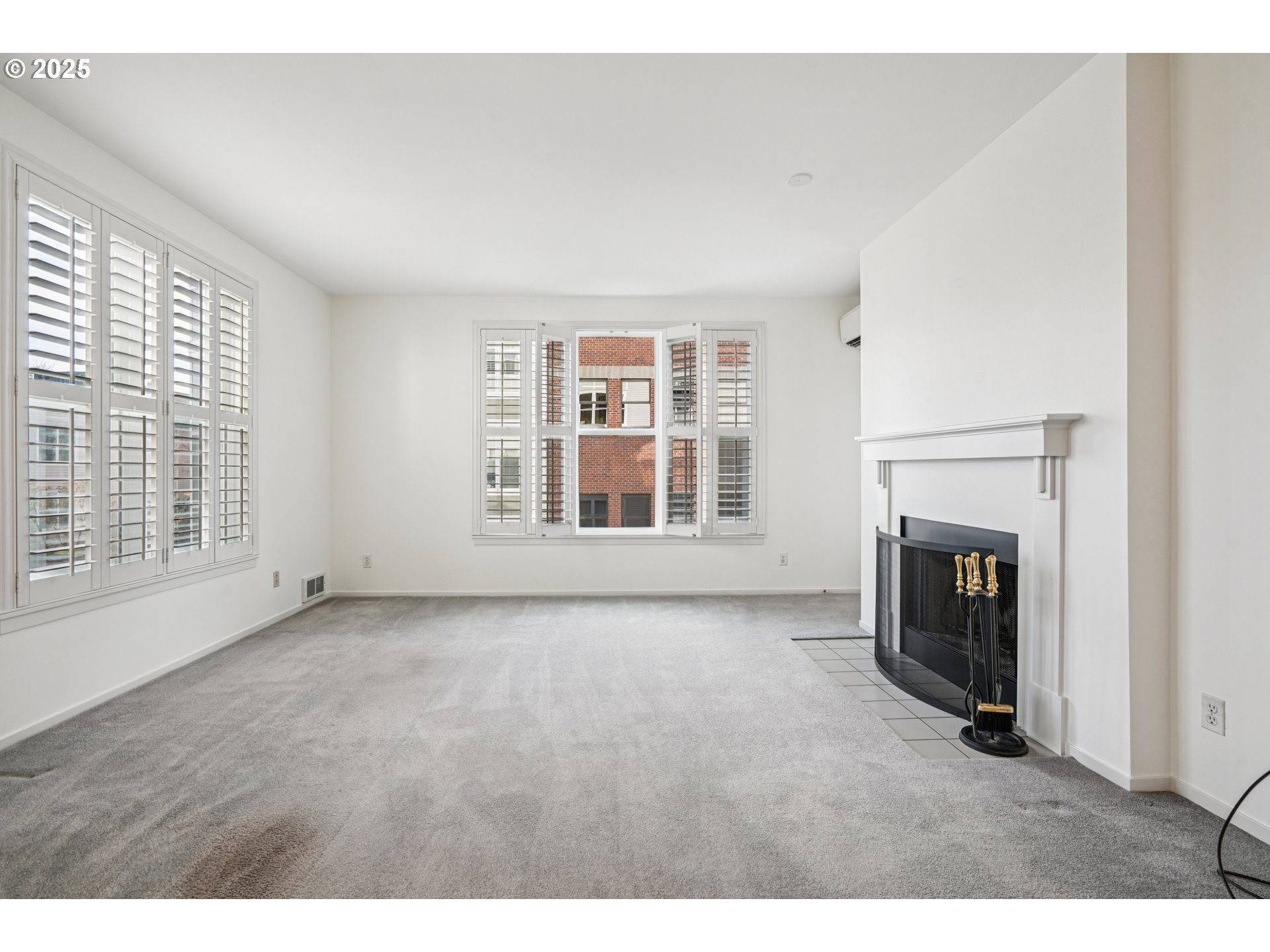 1616 South Harbor Way, Unit 402 Portland, OR 97201 - Photo 8 of 34 a view of an empty room with a fireplace and a window