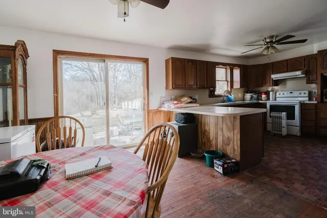 a bedroom with furniture and a large window