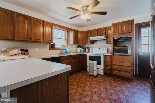 a kitchen with a refrigerator sink and cabinets