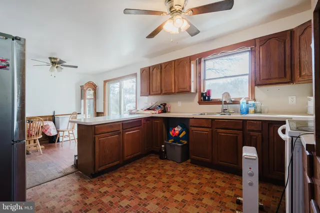 a kitchen with a sink cabinets and window