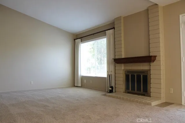a view of empty room with a fireplace