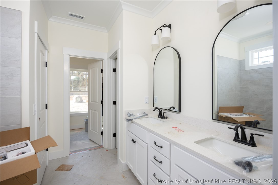 1808 Alderman Mill Road Dunn, NC 28334 - Photo 11 of 13 a bathroom with a double vanity sink and a mirror
