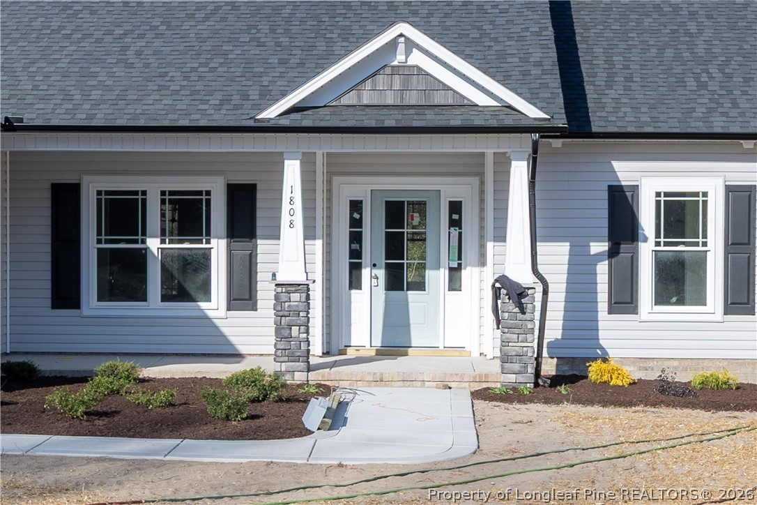 1808 Alderman Mill Road Dunn, NC 28334 - Photo 3 of 13 a front view of a house with a garden