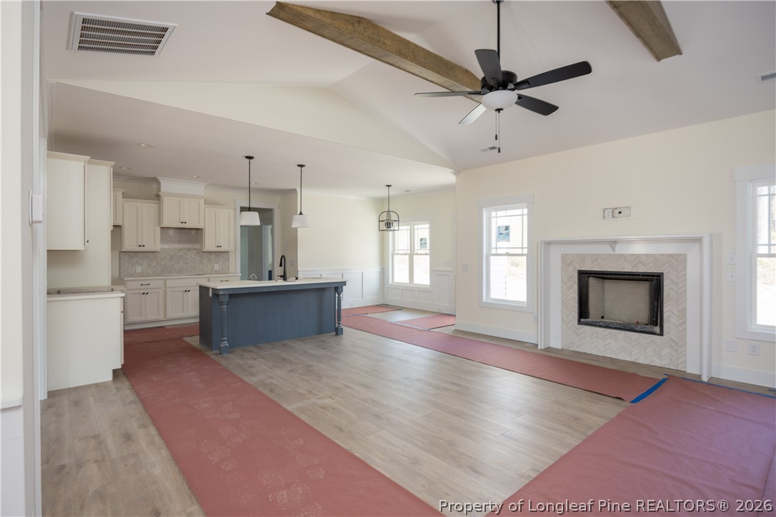 1808 Alderman Mill Road Dunn, NC 28334 - Photo 5 of 13 a large kitchen with a stove fireplace and wooden floor