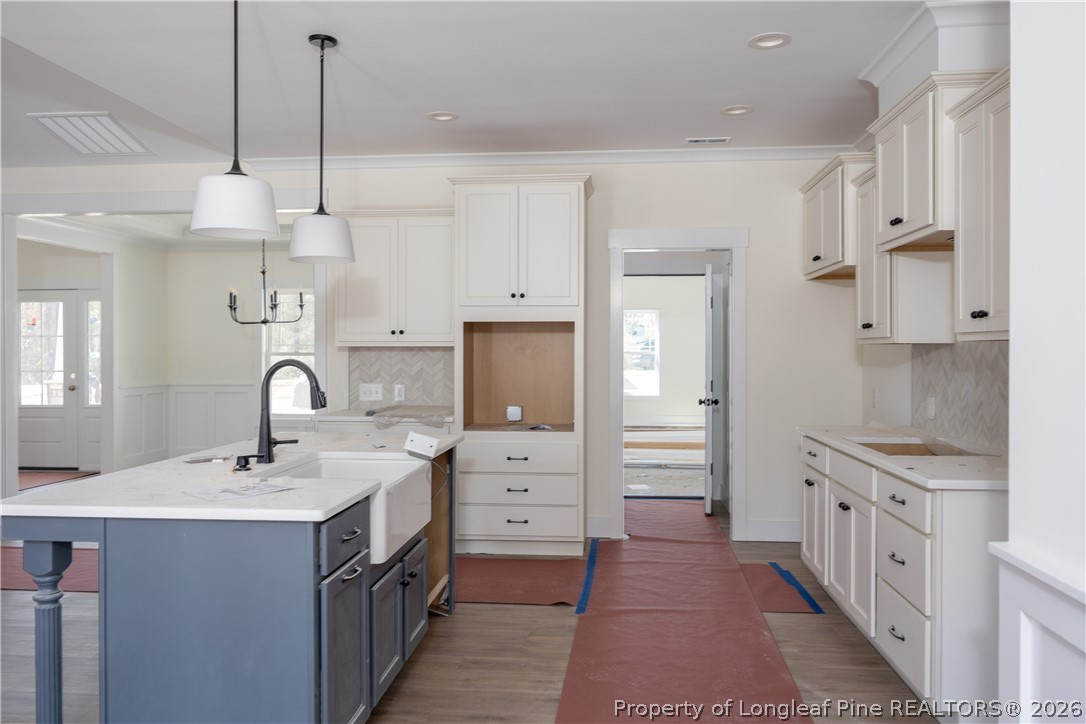 1808 Alderman Mill Road Dunn, NC 28334 - Photo 7 of 13 a kitchen with white cabinets and sink