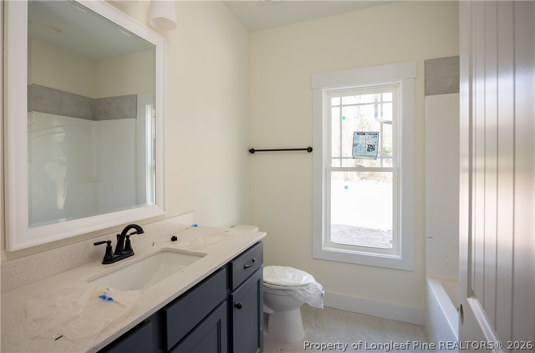 1808 Alderman Mill Road Dunn, NC 28334 - Photo 8 of 13 a bathroom with a sink a toilet and shower
