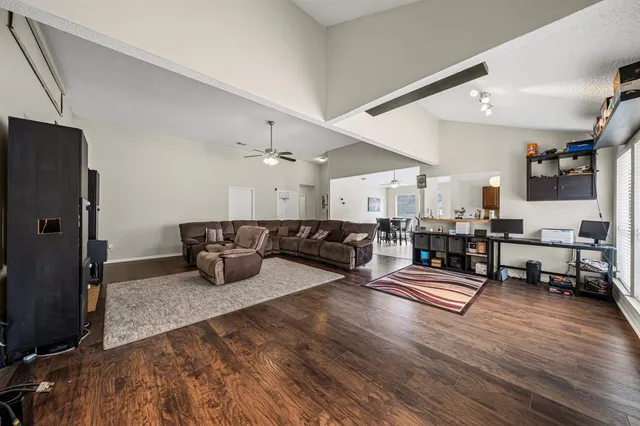 a living room with furniture kitchen view and a refrigerator