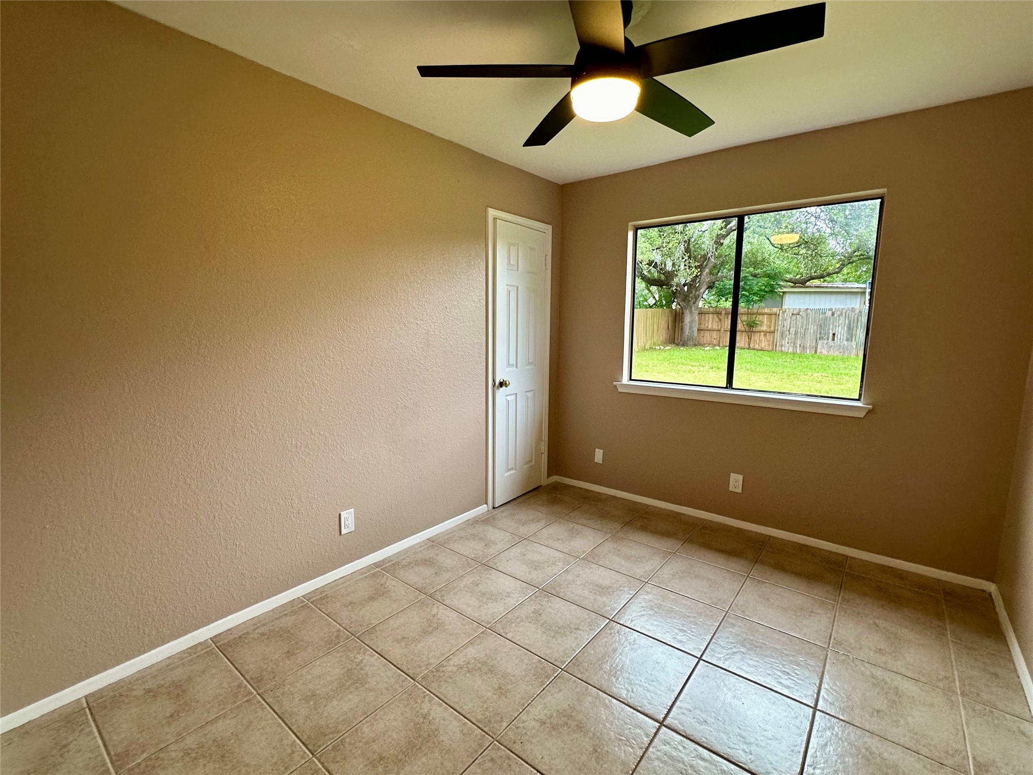 709 Brookside Pass Cedar Park, TX 78613 - Photo 7 of 10 This room features tile flooring, a ceiling fan with integrated lighting, and a window providing a view of the exterior yard and fencing