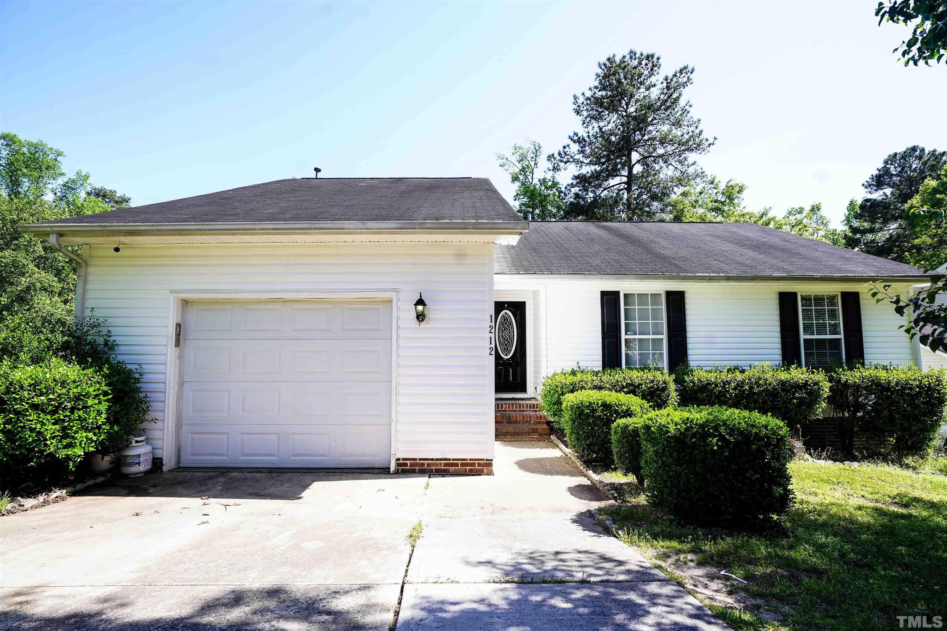 1212 Cranmoore Court Raleigh, NC 27604 - Photo 1 of 14 a front view of a house with a garden
