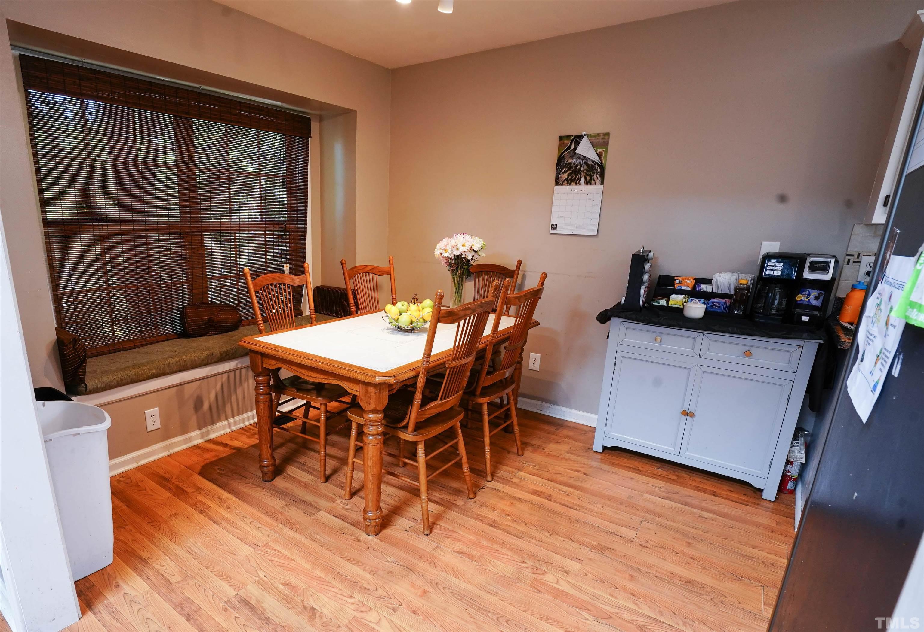 1212 Cranmoore Court Raleigh, NC 27604 - Photo 13 of 14 a view of a dining room with furniture and wooden floor