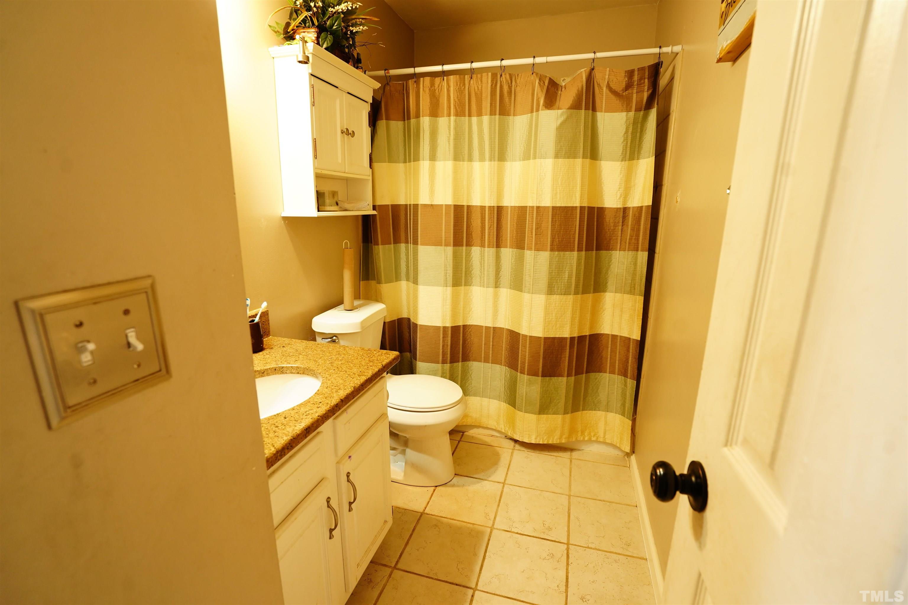 1212 Cranmoore Court Raleigh, NC 27604 - Photo 3 of 14 a bathroom with a toilet and shower