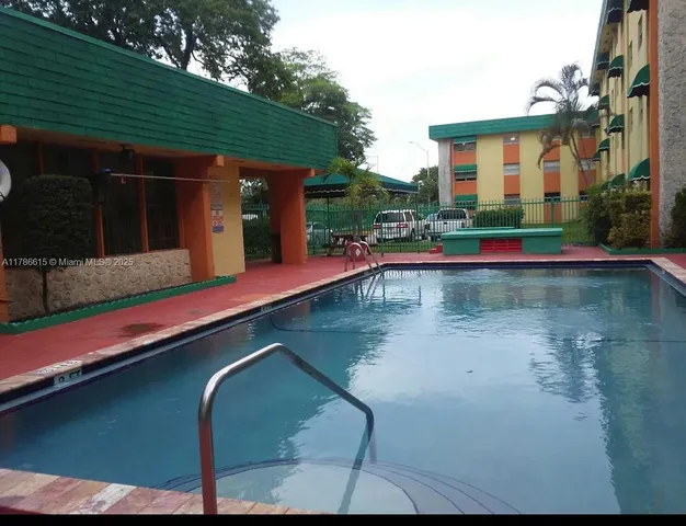 a view of a patio with swimming pool table and chairs