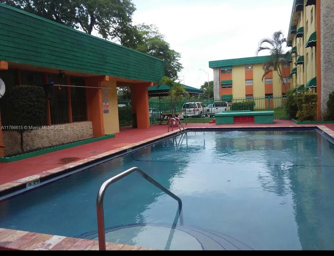666 West 81st Street, Unit 127 Hialeah, FL 33014 - Photo 2 of 10 a view of a patio with swimming pool table and chairs