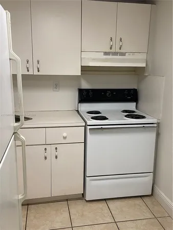 a stove top oven sitting inside of a kitchen
