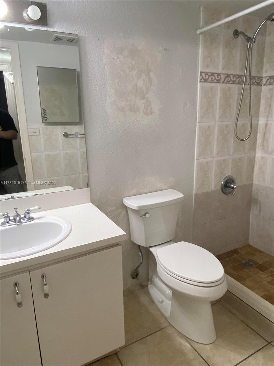 666 West 81st Street, Unit 127 Hialeah, FL 33014 - Photo 6 of 10 a bathroom with a sink a toilet and shower