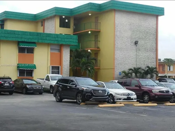 a couple of cars parked in front of a house