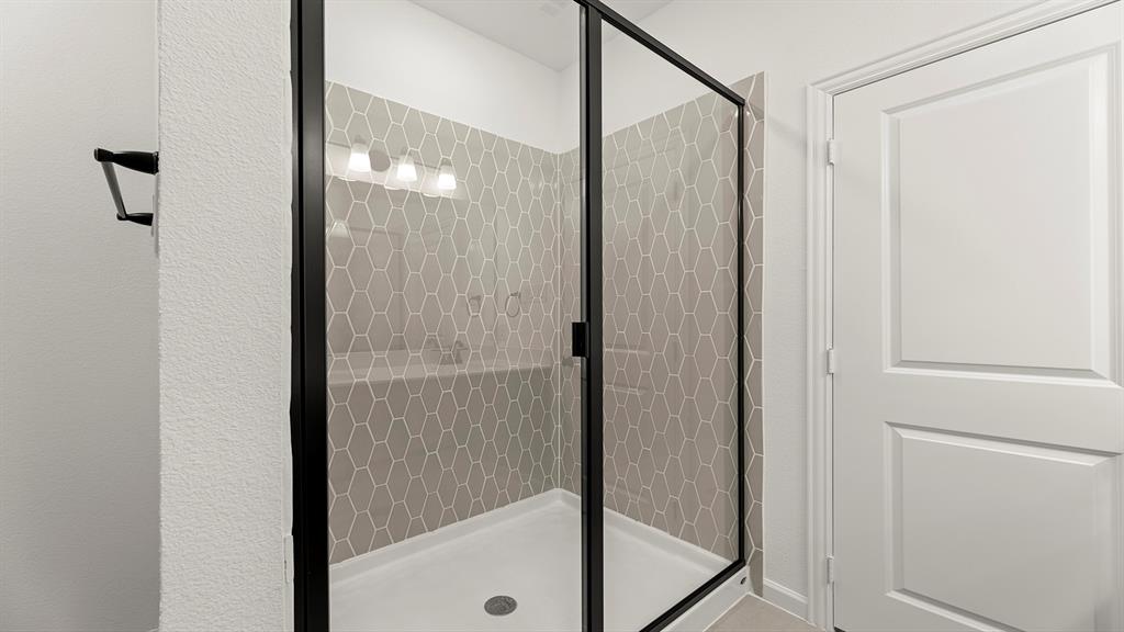 2516 YO Rnch Road Anna, TX 75409 - Photo 23 of 30 a bathroom with a glass shower door