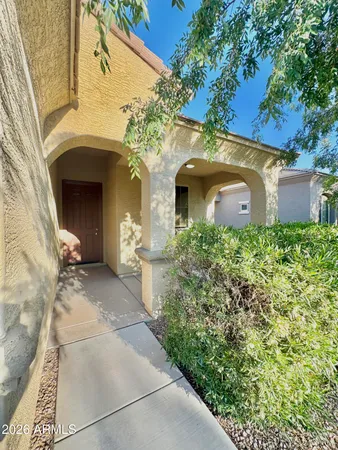 a front view of a house with plants