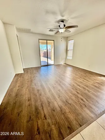 a kitchen with stainless steel appliances granite countertop a stove top oven a sink a counter top space cabinets and a window