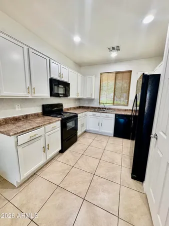 a kitchen with stainless steel appliances a refrigerator sink stove microwave and cabinets