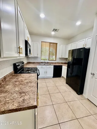 a view of a livingroom with wooden floor and a ceiling fan