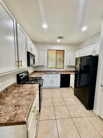 a kitchen with a stove a sink and a microwave