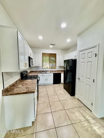 a kitchen with stainless steel appliances granite countertop a refrigerator sink and cabinets
