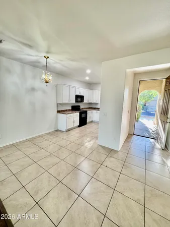 a view of a kitchen with kitchen appliances and cabinets