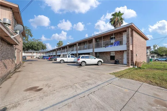 a view of building with car parked