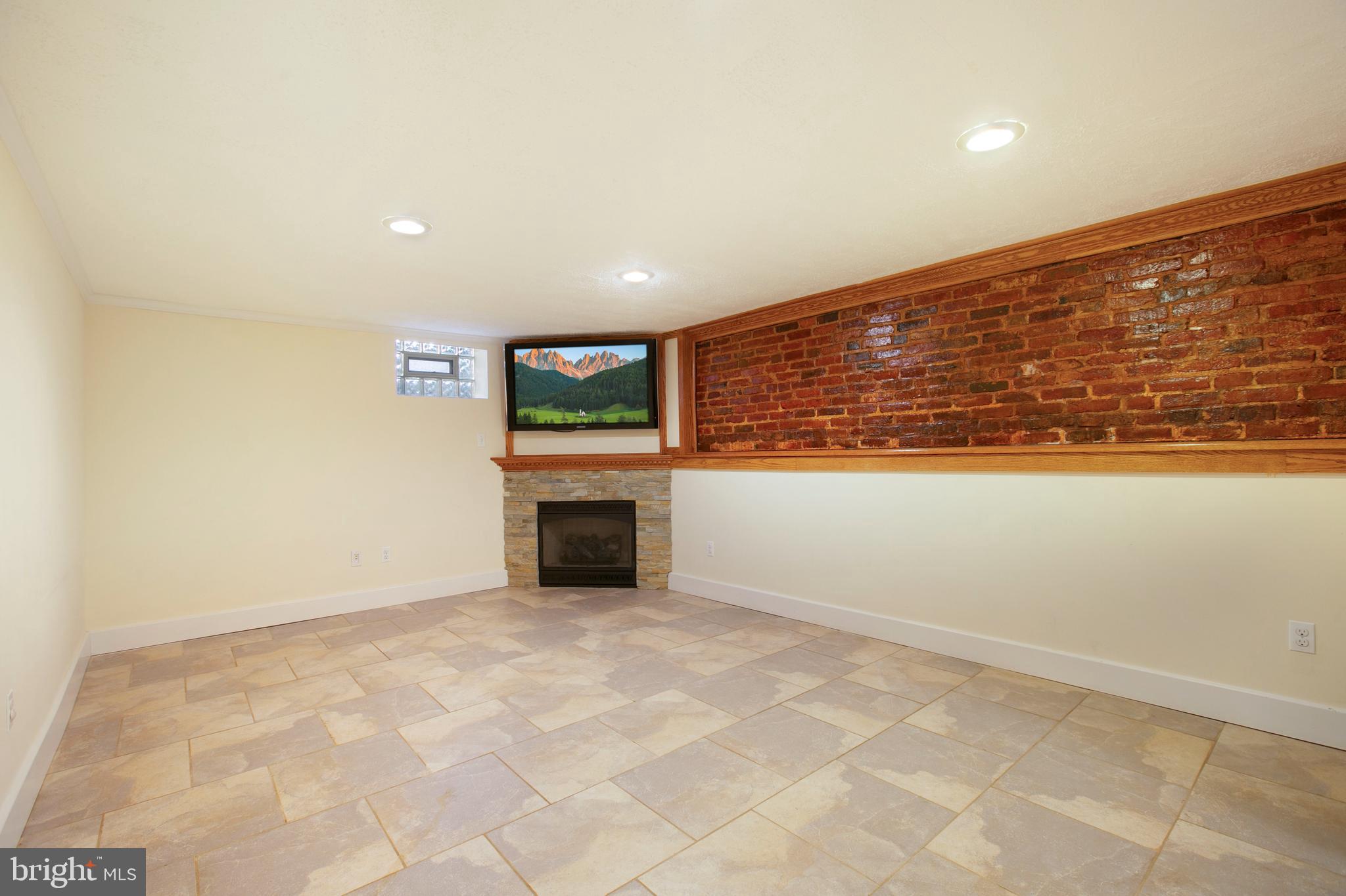 522 Overbrook Road Baltimore, MD 21212 - Photo 26 of 37 Family room with gas fpl & exposed brick wall.