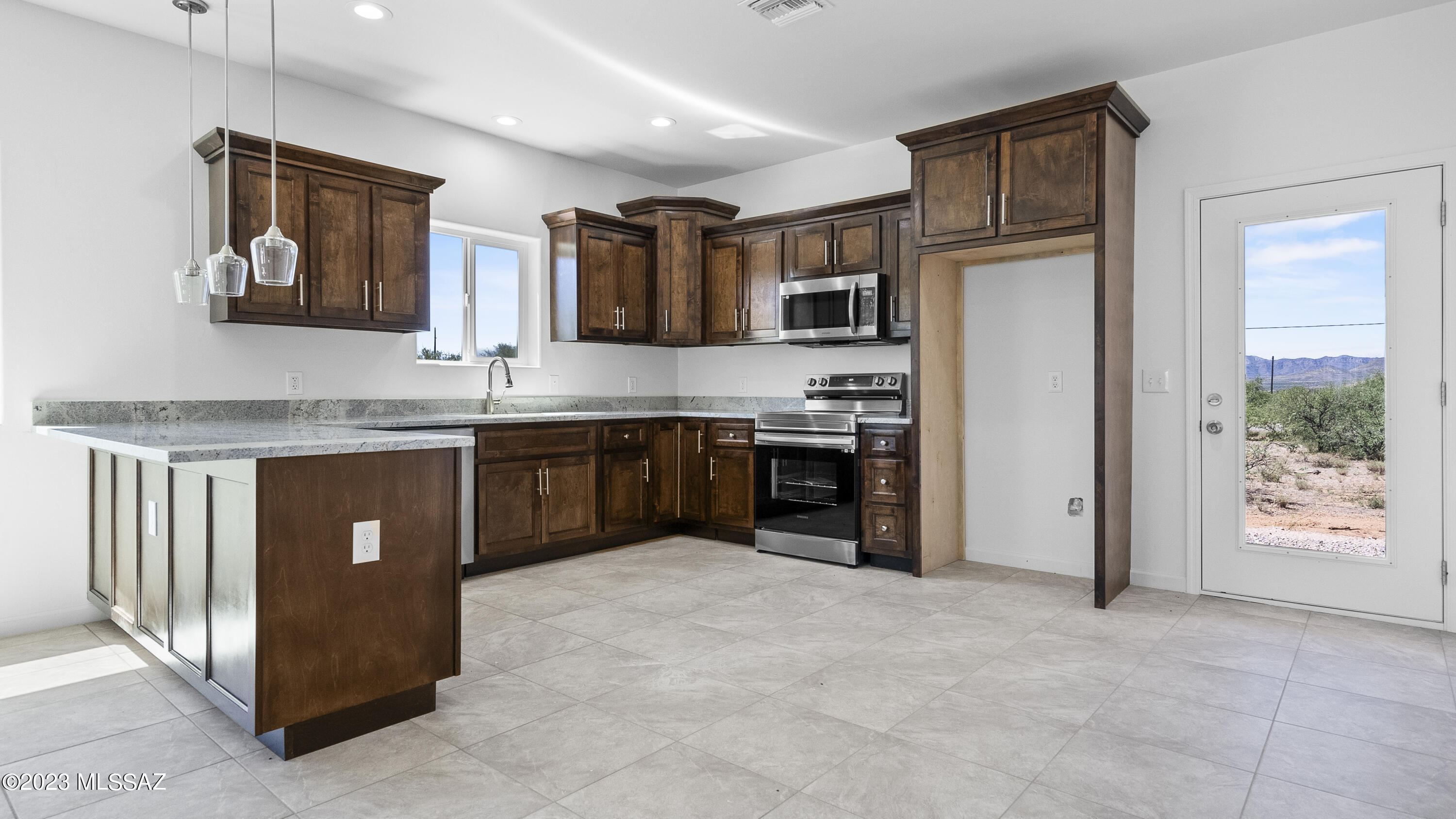 1832 America Court Rio Rico, AZ 85648 - Photo 11 of 19 a kitchen with stainless steel appliances granite countertop a refrigerator a sink a stove and a microwave