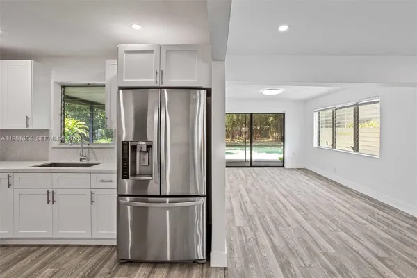 a kitchen with stainless steel appliances a refrigerator sink and cabinets