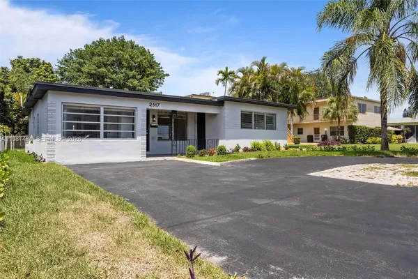 a view of a house with outdoor space and palm trees