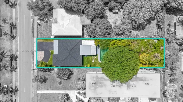 an aerial view of a house with a yard