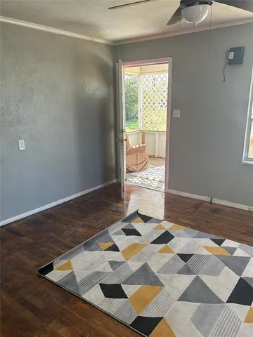 a view of a bedroom with wooden floor and a sink