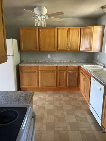 a kitchen with stainless steel appliances granite countertop a sink stove and cabinets