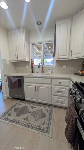 a kitchen with a sink stove and cabinets