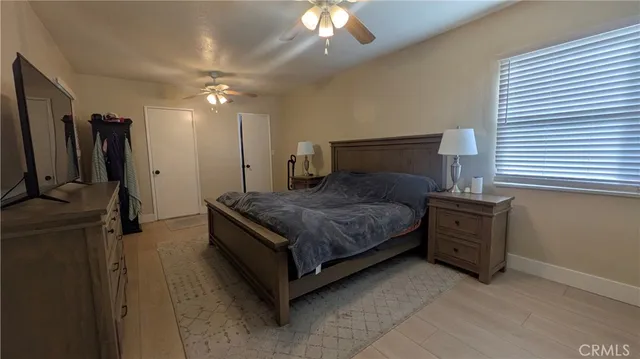 a spacious bedroom with a bed and a chandelier