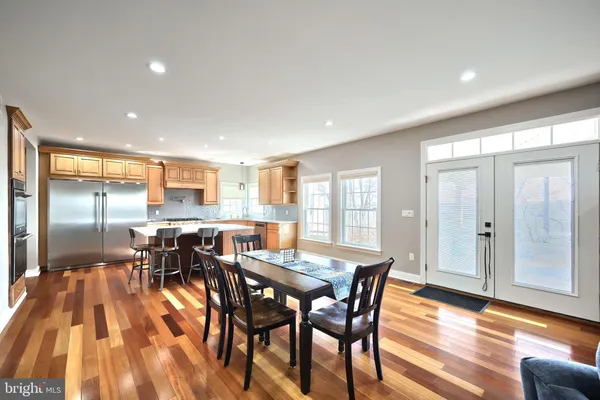 a kitchen with kitchen island a large counter top space stainless steel appliances and a window