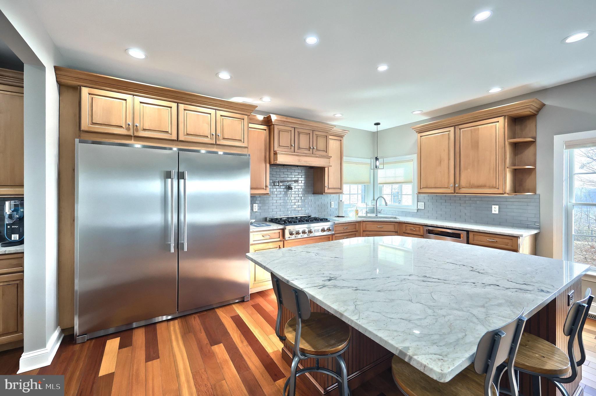 4440 Beards School Road Spring Grove, PA 17362 - Photo 19 of 66 a kitchen with kitchen island a large counter top space stainless steel appliances and a window