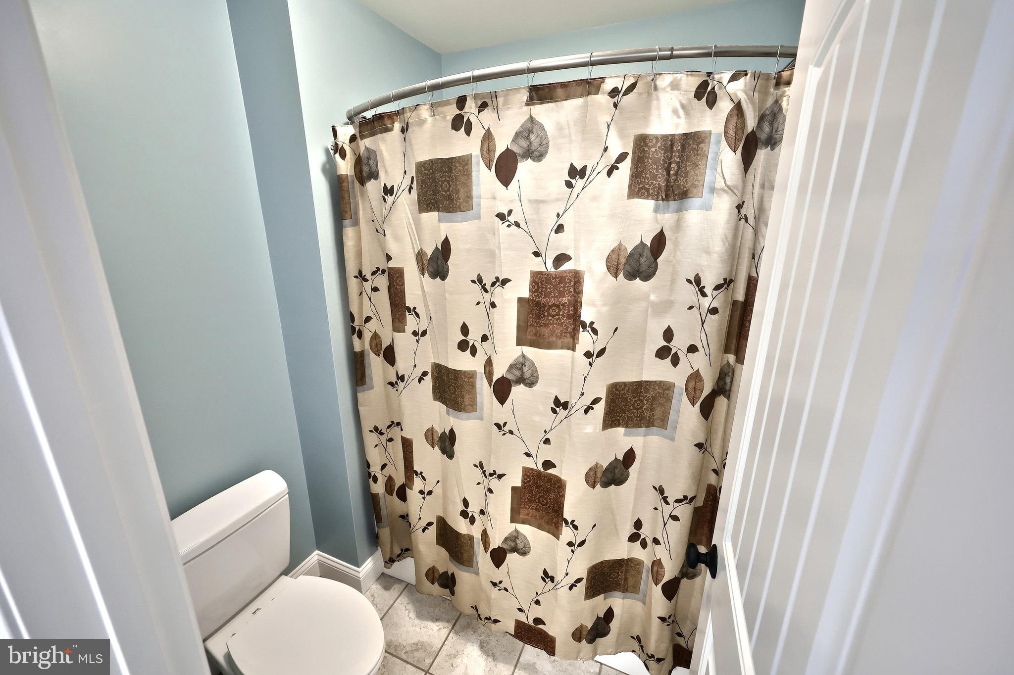4440 Beards School Road Spring Grove, PA 17362 - Photo 29 of 66 a white toilet sitting next to a shower curtain