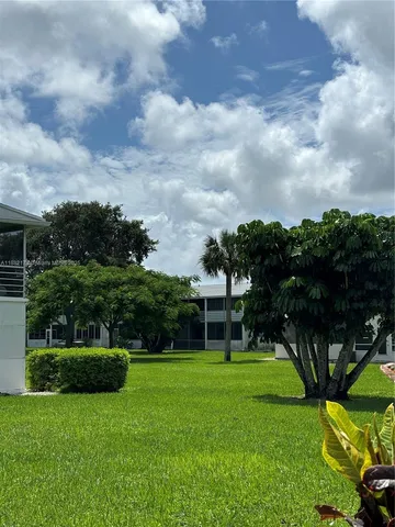 a view of a garden with a house in the background
