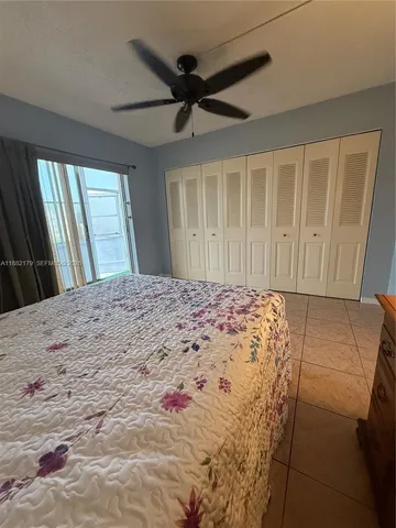 a large bed in a bedroom next to a window