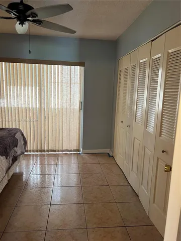 a view of a livingroom with a ceiling fan and window