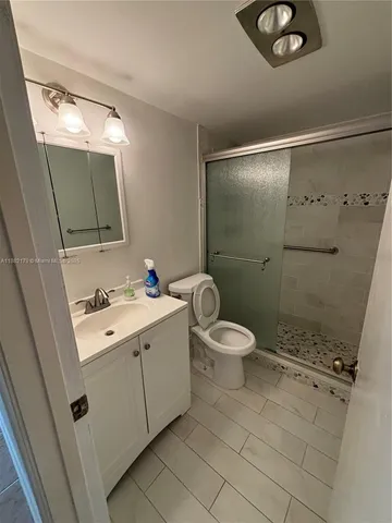 a white toilet sitting next to a bathroom sink