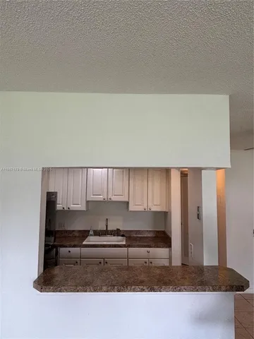 a kitchen with kitchen island cabinets and oven