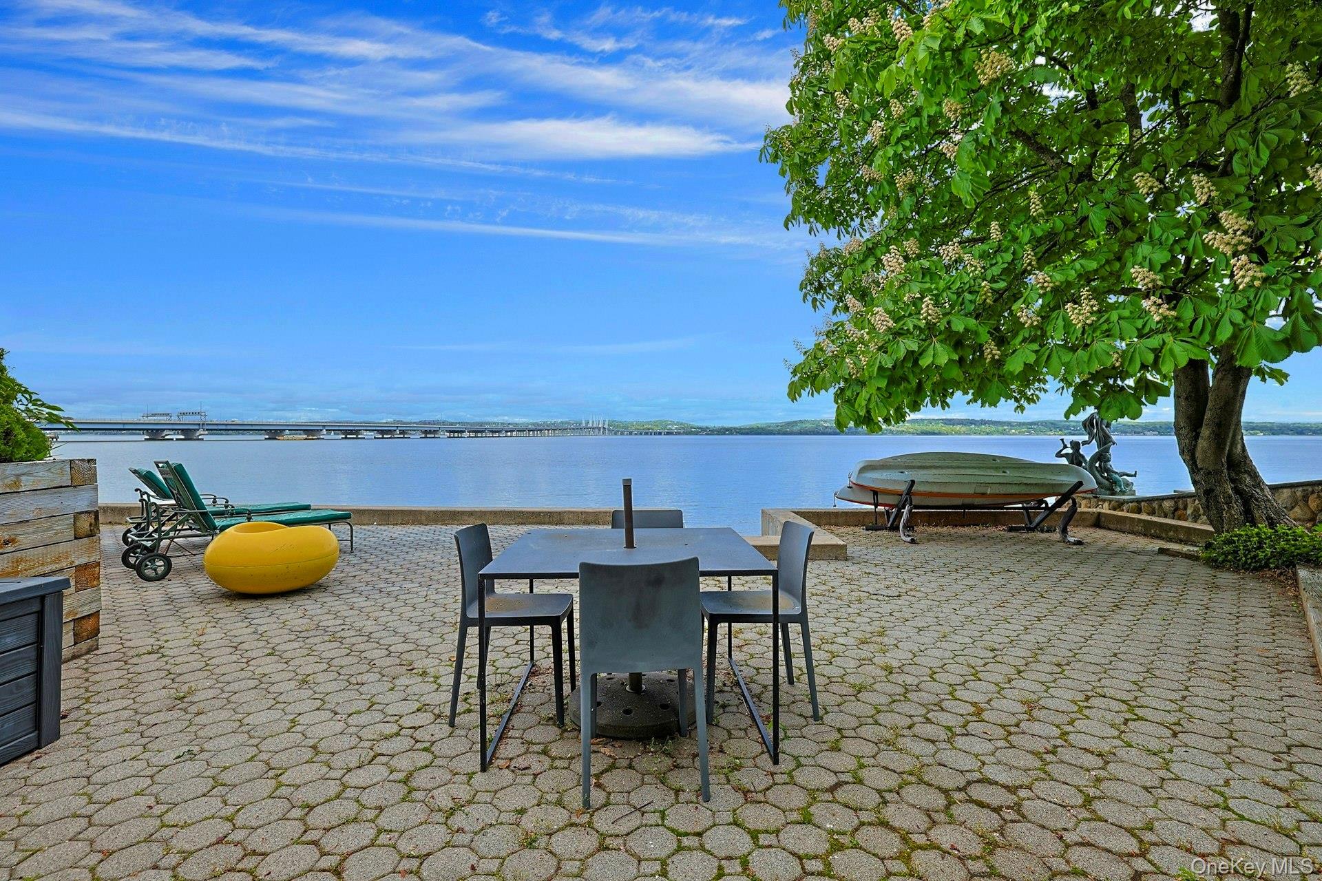 88 River Road Nyack, NY 10960 - Photo 14 of 49 an outdoor sitting area with a table and chairs