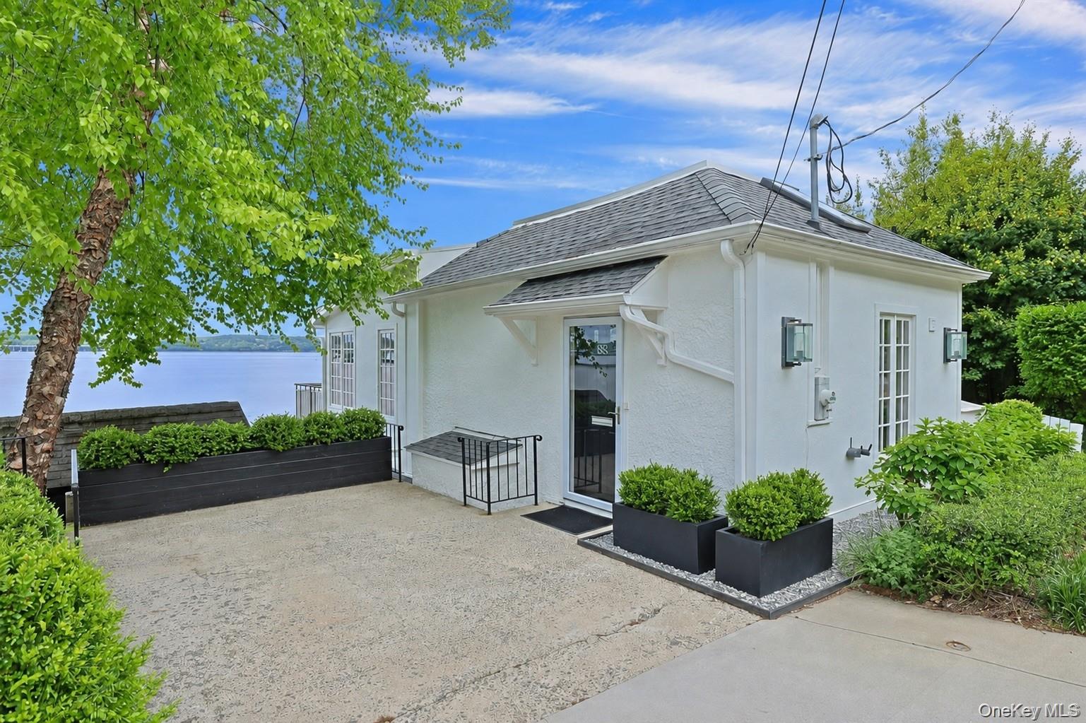 88 River Road Nyack, NY 10960 - Photo 15 of 49 a front view of a house with garden