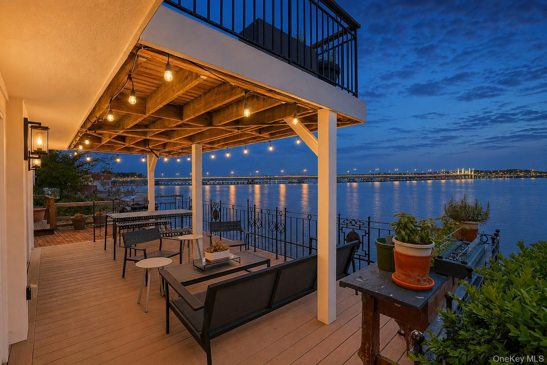 88 River Road Nyack, NY 10960 - Photo 2 of 49 a view of a patio with table and chairs potted plants with wooden floor